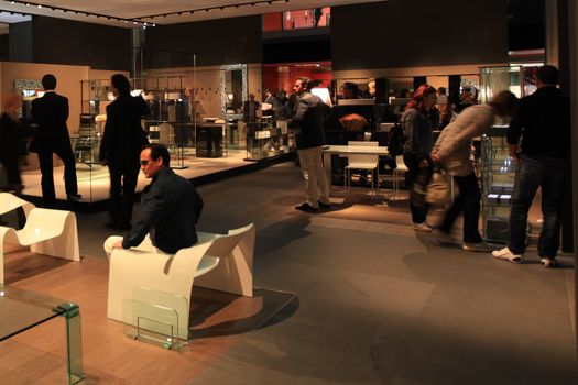 People look at interiors design stands and home architecture solutions visiting 2011 Salone del Mobile, international furnishing accessories exhibition in Milan, Italy.