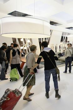 People visit interiors design stands and home architecture solutions at 2011 Salone del Mobile, international furnishing accessories exhibition in Milan, Italy.