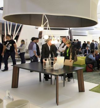 People visit interiors design stands and home architecture solutions at 2011 Salone del Mobile, international furnishing accessories exhibition in Milan, Italy.