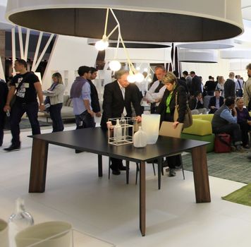 People visit interiors design stands and home architecture solutions at 2011 Salone del Mobile, international furnishing accessories exhibition in Milan, Italy.