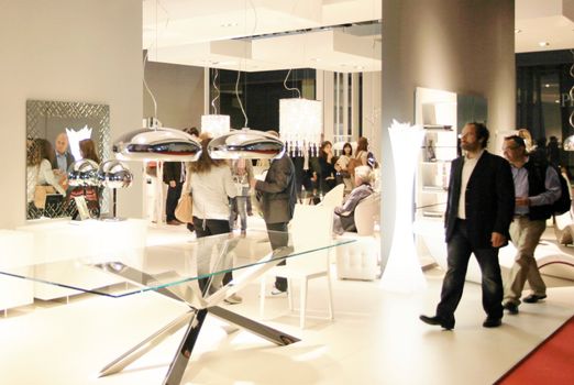 People visit interiors design stands and home architecture solutions at 2011 Salone del Mobile, international furnishing accessories exhibition in Milan, Italy.