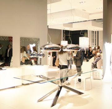 People visit interiors design stands and home architecture solutions at 2011 Salone del Mobile, international furnishing accessories exhibition in Milan, Italy.