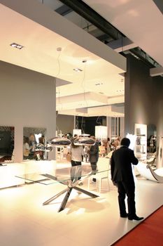 People visit interiors design stands and home architecture solutions at 2011 Salone del Mobile, international furnishing accessories exhibition in Milan, Italy.