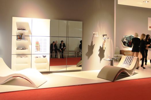 People visit interiors design stands and home architecture solutions at 2011 Salone del Mobile, international furnishing accessories exhibition in Milan, Italy.