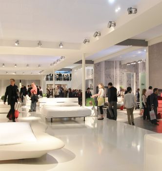 People visit interiors design stands and home architecture solutions at 2011 Salone del Mobile, international furnishing accessories exhibition in Milan, Italy.