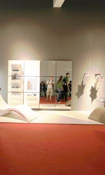 People visit interiors design stands and home architecture solutions at 2011 Salone del Mobile, international furnishing accessories exhibition in Milan, Italy.