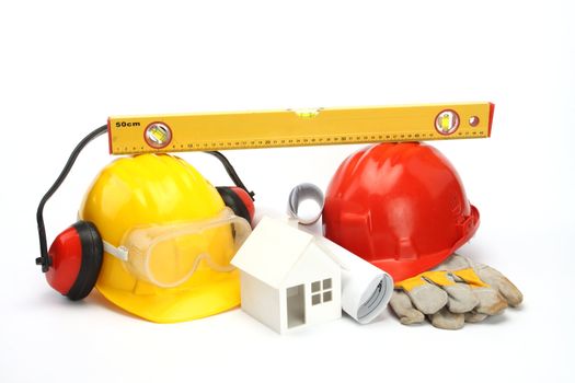 construction concept- house model, industrial tools and protective gear 