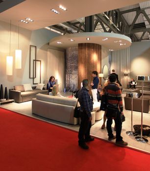 People visit interiors design stands and home architecture solutions at 2011 Salone del Mobile, international furnishing accessories exhibition in Milan, Italy.