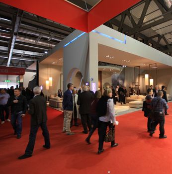 People visit interiors design stands and home architecture solutions at 2011 Salone del Mobile, international furnishing accessories exhibition in Milan, Italy.