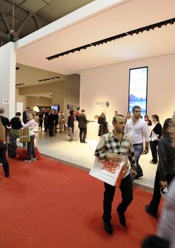 People visit interiors design stands and home architecture solutions at 2011 Salone del Mobile, international furnishing accessories exhibition in Milan, Italy.