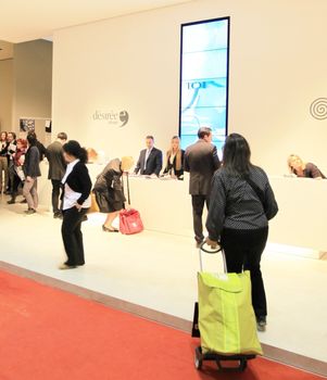 People visit interiors design stands and home architecture solutions at 2011 Salone del Mobile, international furnishing accessories exhibition in Milan, Italy.