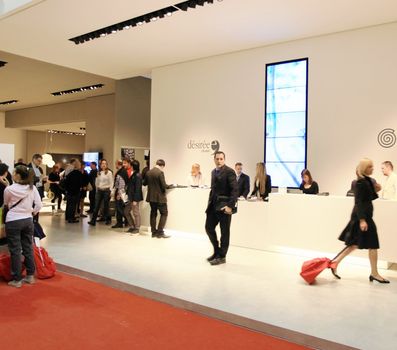 People visit interiors design stands and home architecture solutions at 2011 Salone del Mobile, international furnishing accessories exhibition in Milan, Italy.