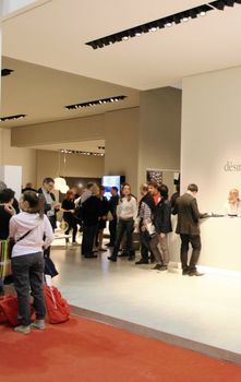 People visit interiors design stands and home architecture solutions at 2011 Salone del Mobile, international furnishing accessories exhibition in Milan, Italy.