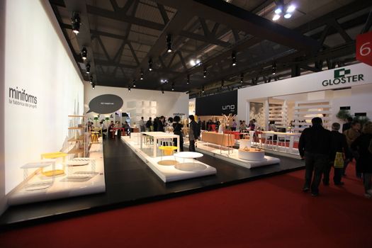 People visit interiors design stands and home architecture solutions at 2011 Salone del Mobile, international furnishing accessories exhibition in Milan, Italy.