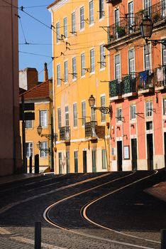 Tram rails in Lisbon, colored home and typical street, Portugal