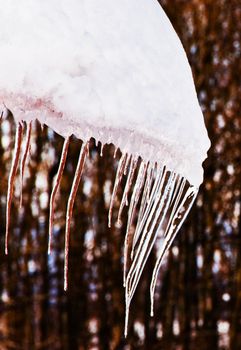 Ice icicles hanging down from a roof