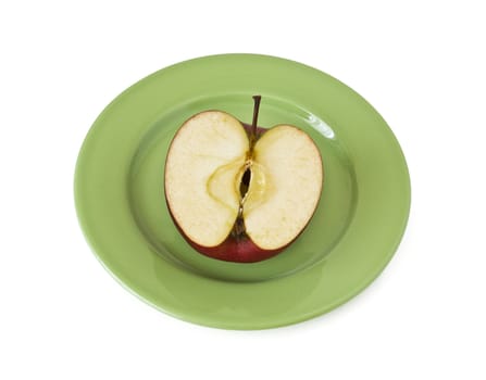 Half an apple on a plate on a white background