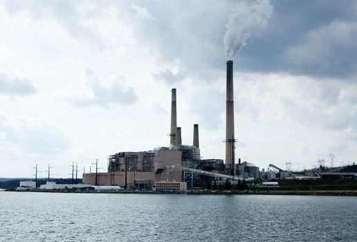 Coal fueled electricity power station by the side of a lake