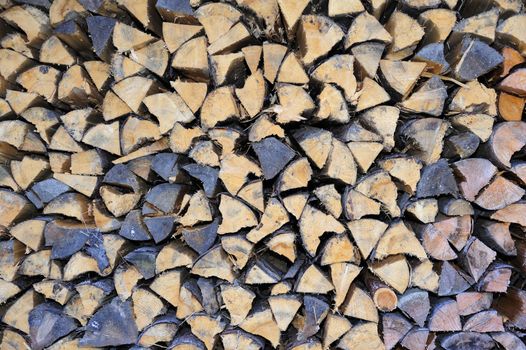 Close-up of the ends of logs in a pile of firewood. Suitable for an abstract natural background 