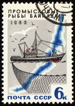 USSR - CIRCA 1966: stamp printed in USSR shows fishing ship, series "Commercial fish of Lake Baikal", circa 1966