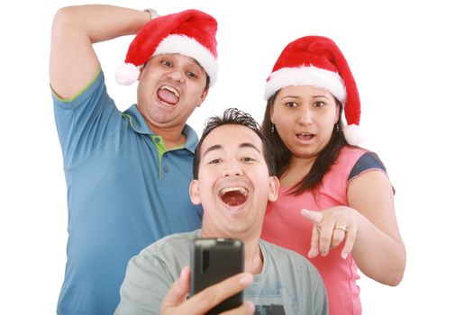 Young friends looking shocked at cell phone with Christmas hat