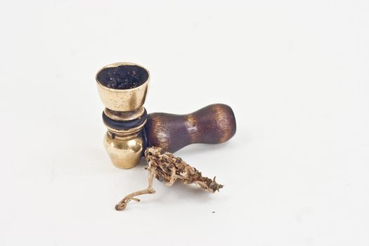 Marijuana and pipe on a white background