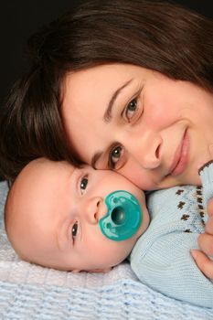 Mother and baby boy on a blue blanket