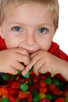 Young boy with a table full of colorful sweets 