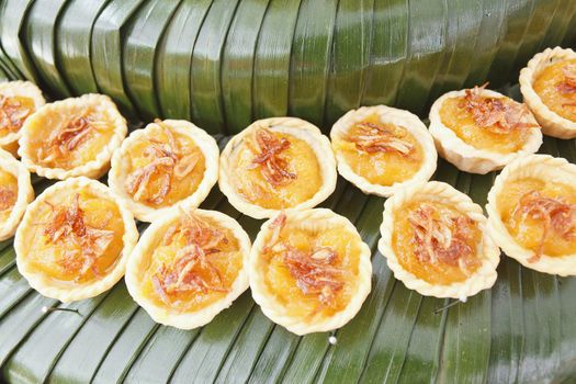 Freshly baked pumpkin pie on banana leaf