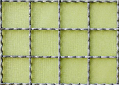 Horizontal and vertical metal grid on green background