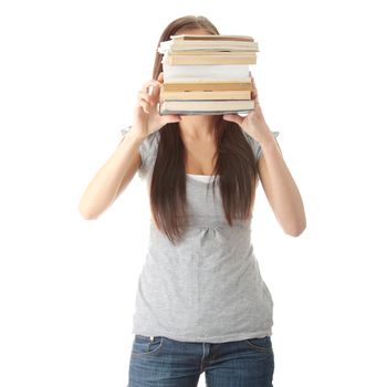 Teenage girl struggling with stack of books isolated