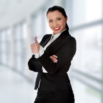 Confident business woman standing wearing elegant clothes with thumb up