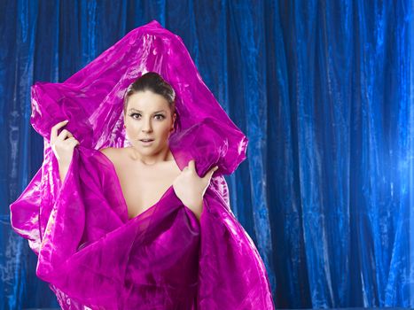 Amazing 40 mega pixels: Mystic and beautiful lady in pink silk on blue background