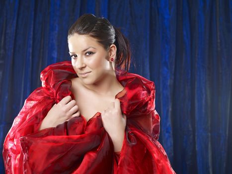Amazing 40 mega pixels: Mystic and beautiful lady in red silk on blue background
