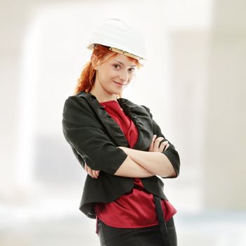 Portrait of confident female worker in helmet.