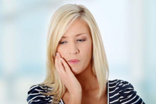 Young woman in pain is having toothache