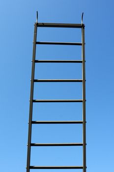 Scaling ladder against blue sky