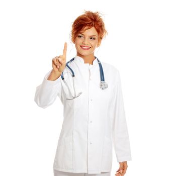 Smiling medical doctor or nurse making a choice with her finger on abstract screan. Isolated on white background