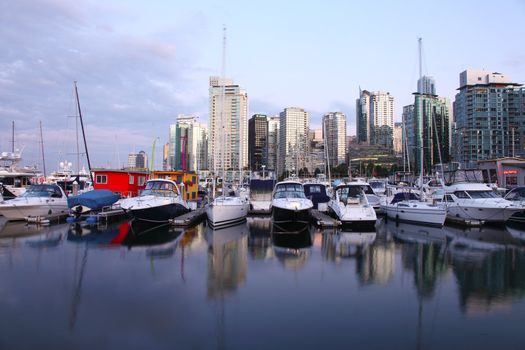 A marina and skyline view of Vancouver BC Canada at dusk.