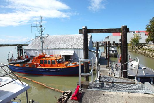 A moored lifeboat in the fishing port south of Richmond BC Canada.