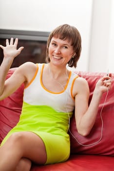 Happy woman listening music with spread arms
