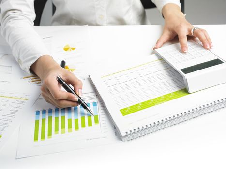 Market Analyze - pen and calculator on papers