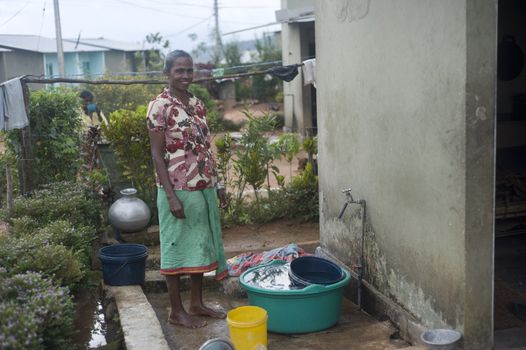 Galle, Sri Lanka - 27th, 2011: Sri Lankan woman washing closes in small village