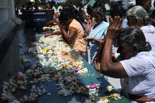 Sri Lankan people praying at Dambulla Golden Temple