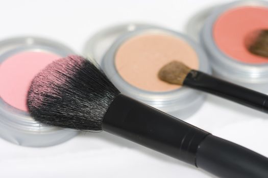 Cosmetics and brushes isolated on white background