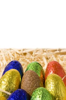 Colourful chocolate easter eggs on white background