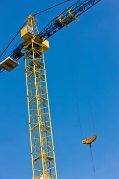 construction site series: yellow crane over blue sky