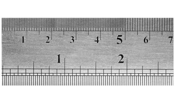 A fragment of a metal ruler with a textural covering