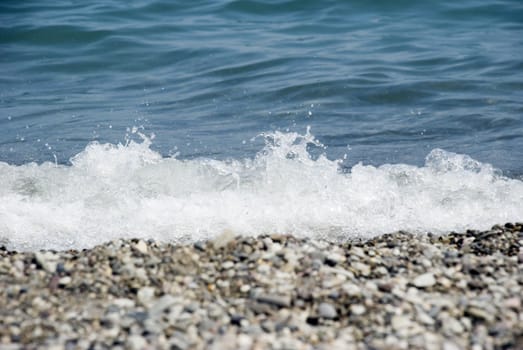 Sea water with foam. Pebble the Crimean peninsula