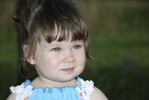 Portrait of the little girl in blue - a white sundress